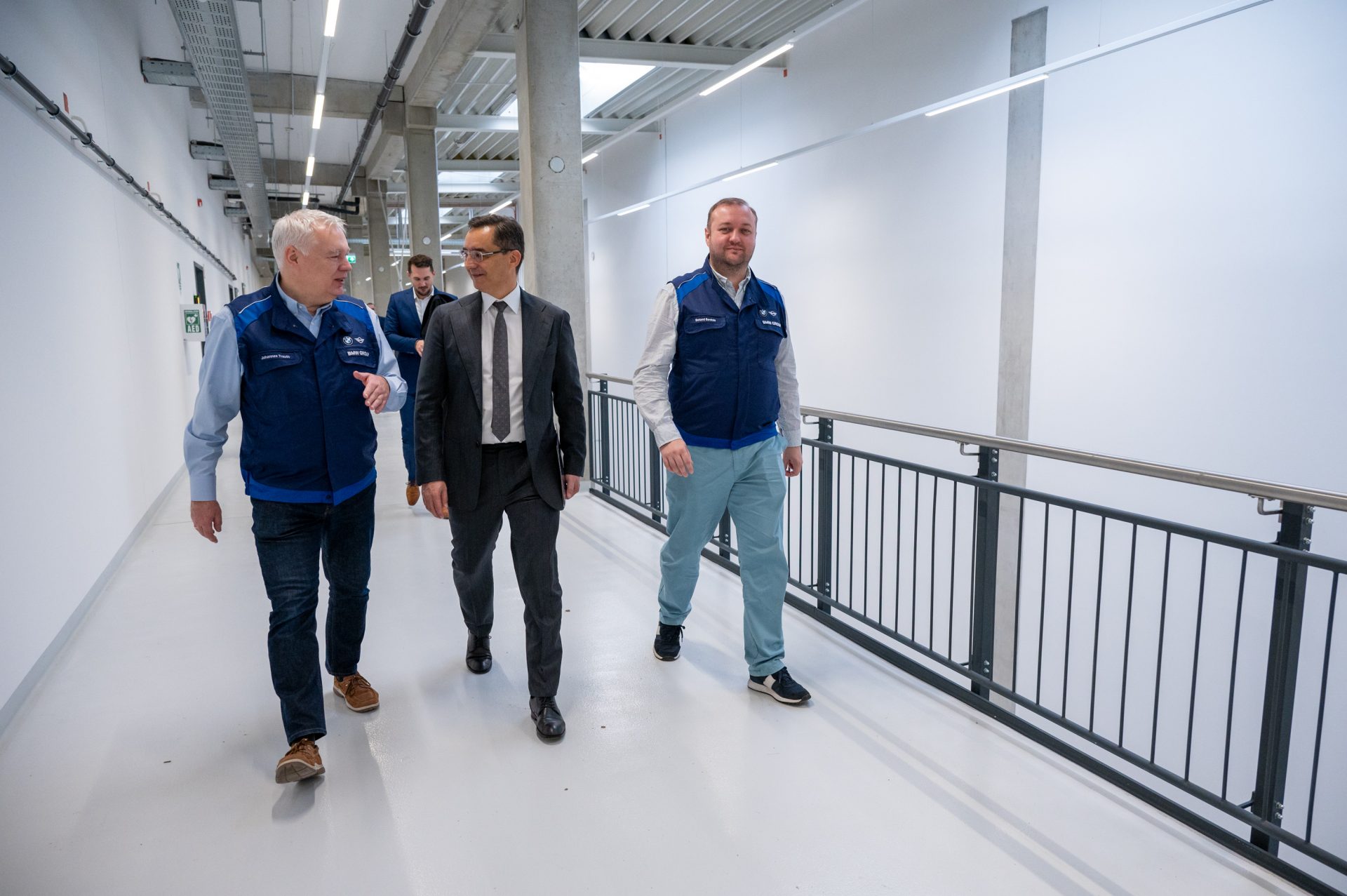 Three men are walking down the aisle