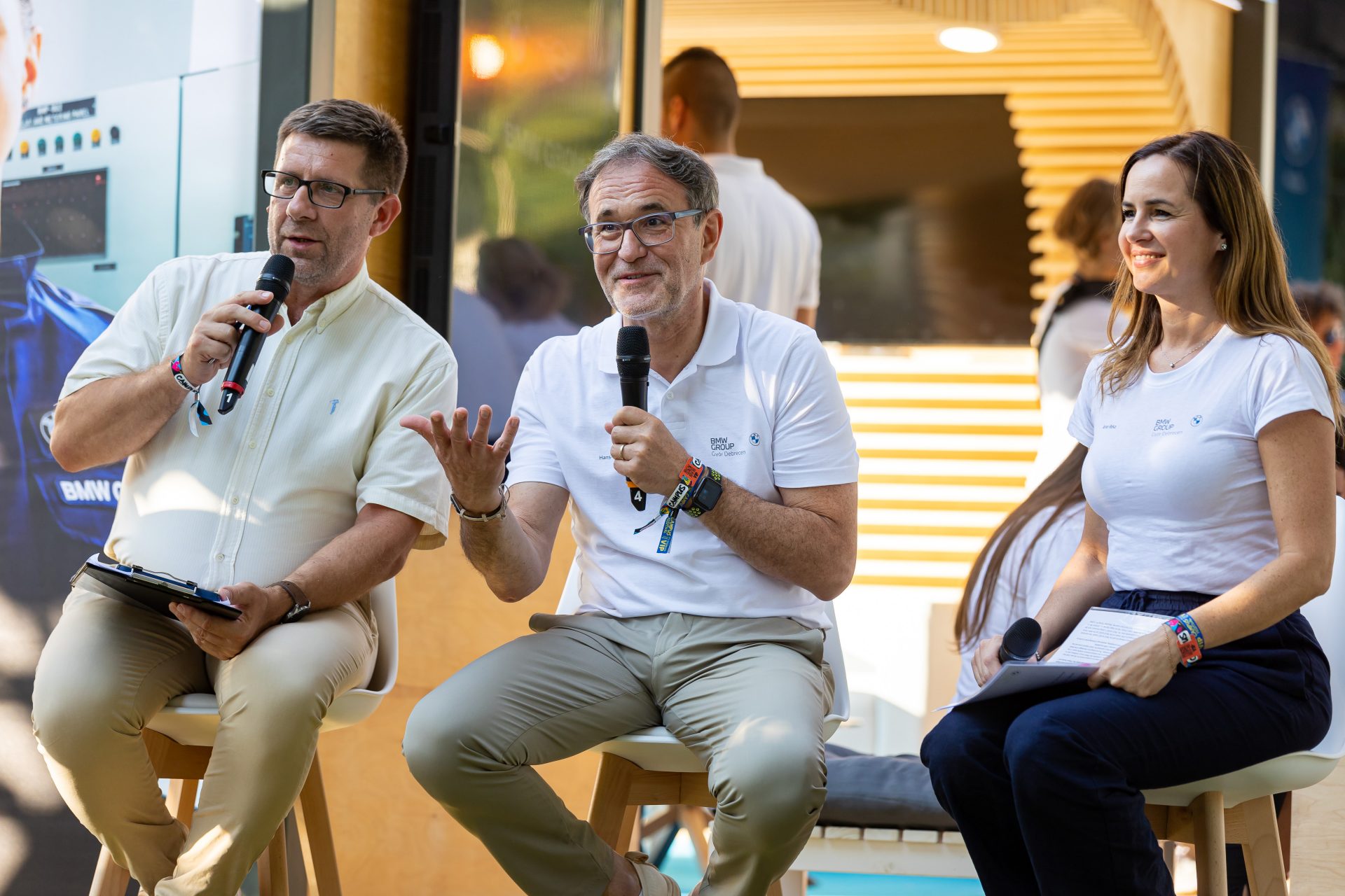 Three people are giving a speech