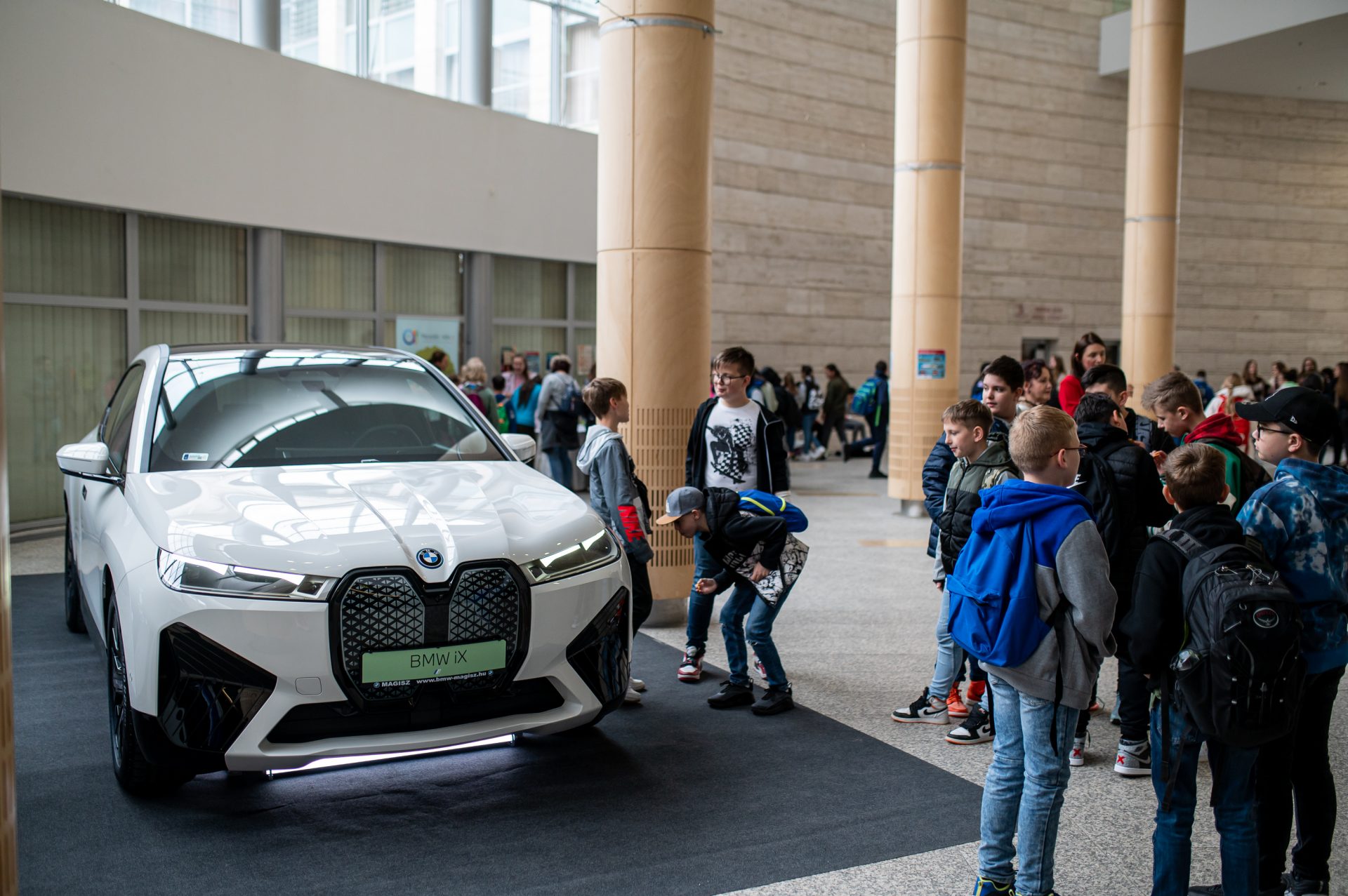 People standing aroung a BMW car