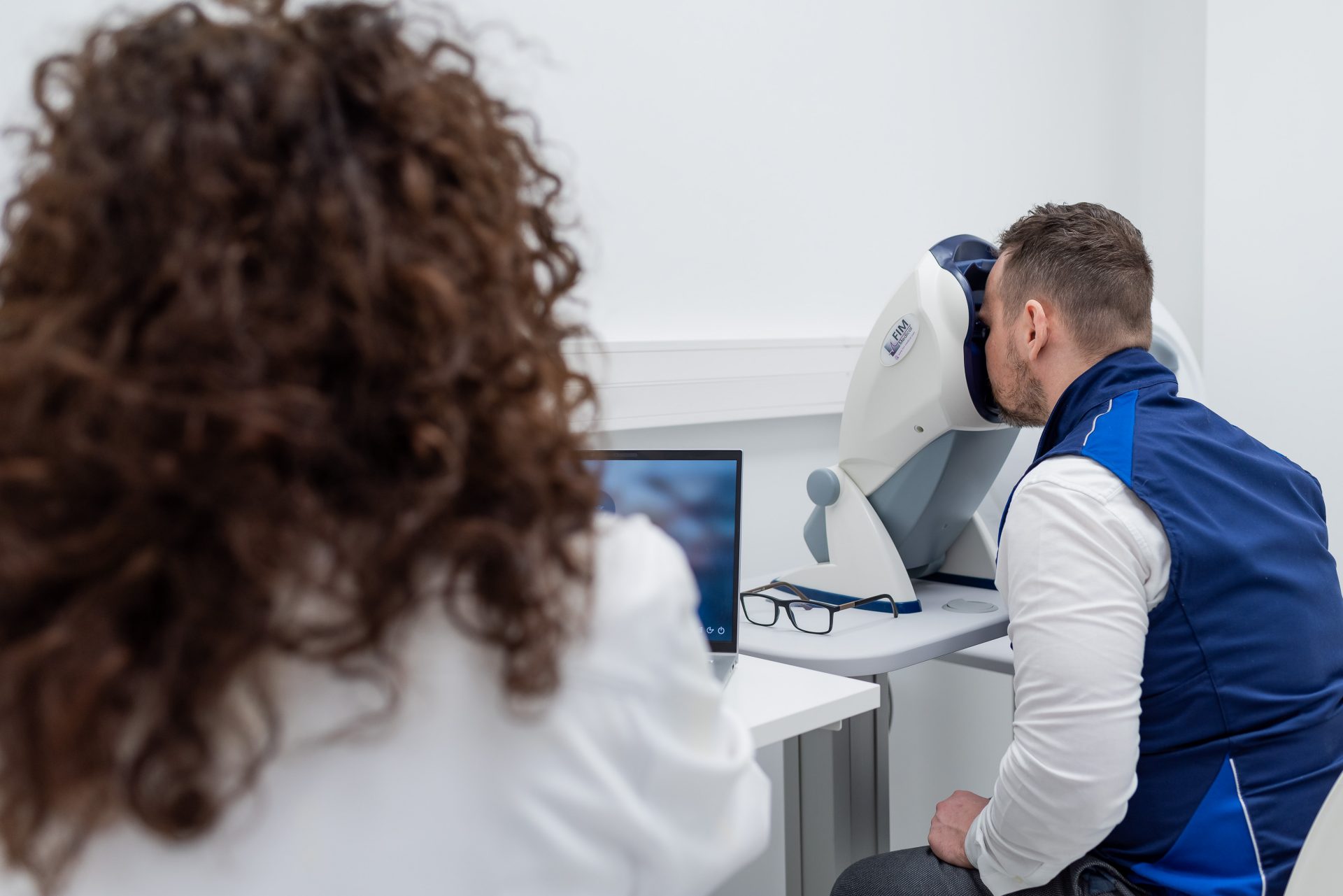 A man is looking at a screen in the treatment room