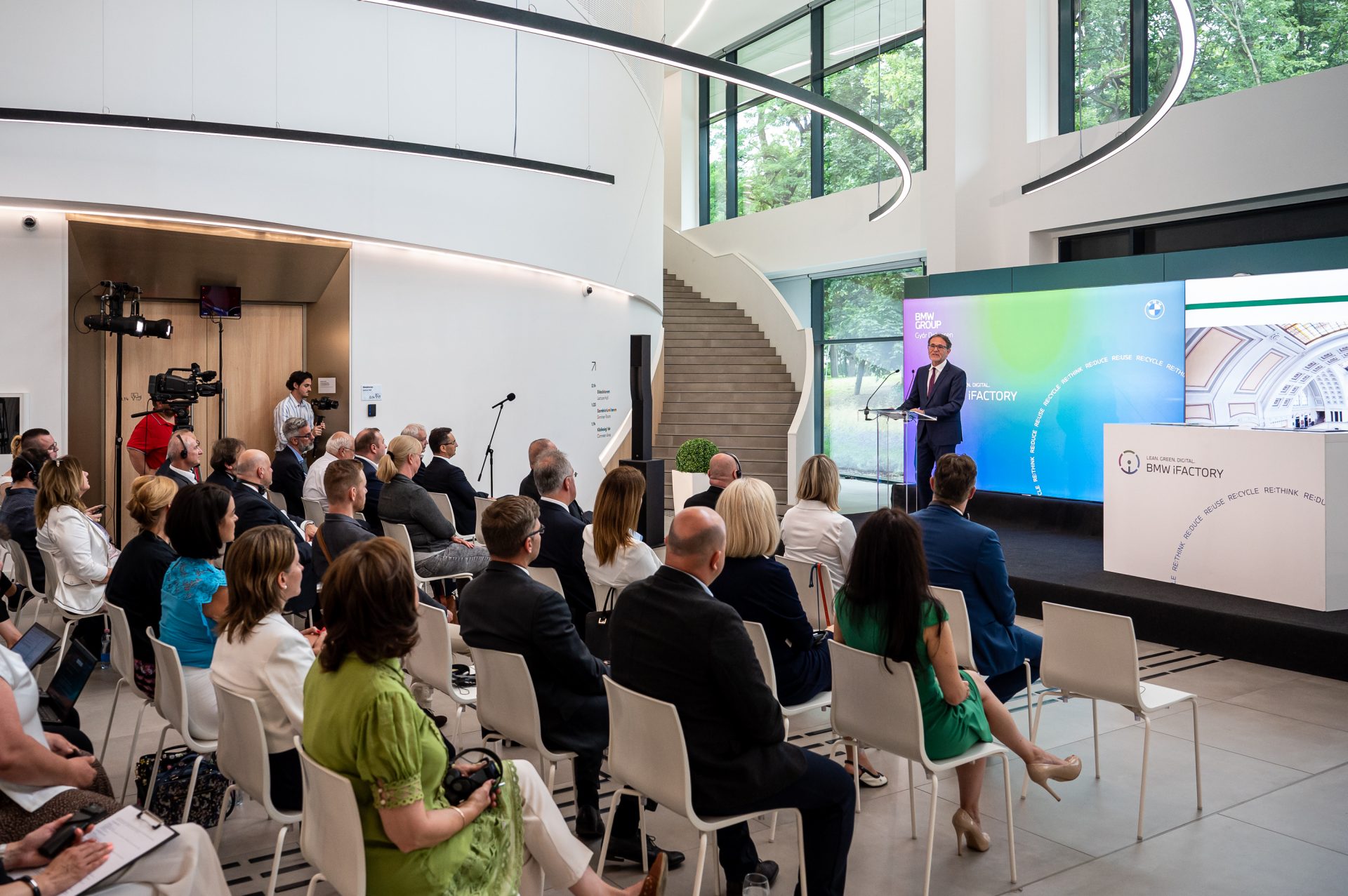 A man is giving a speech in front of a group of people