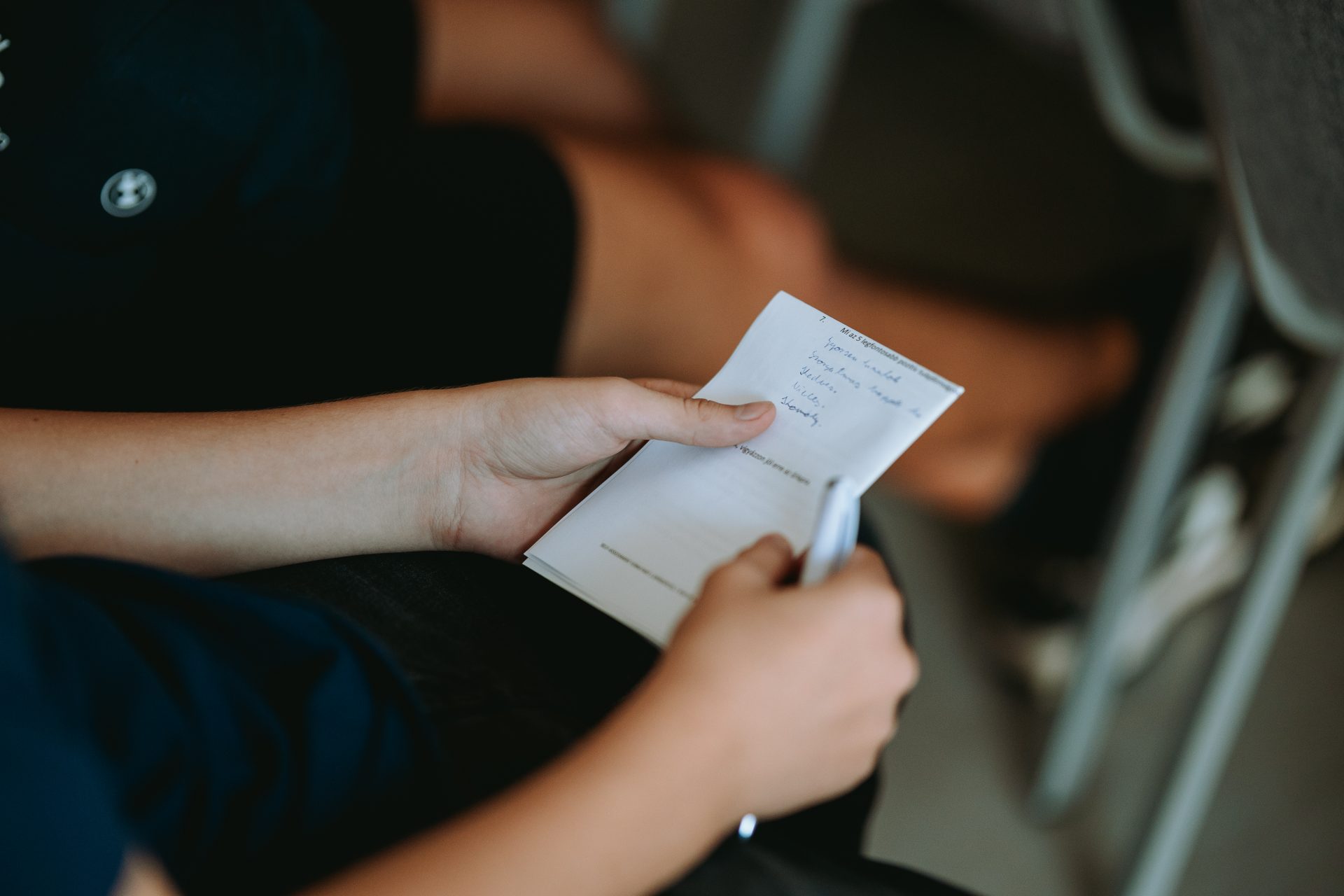 Someone is holding a paper in their hands 