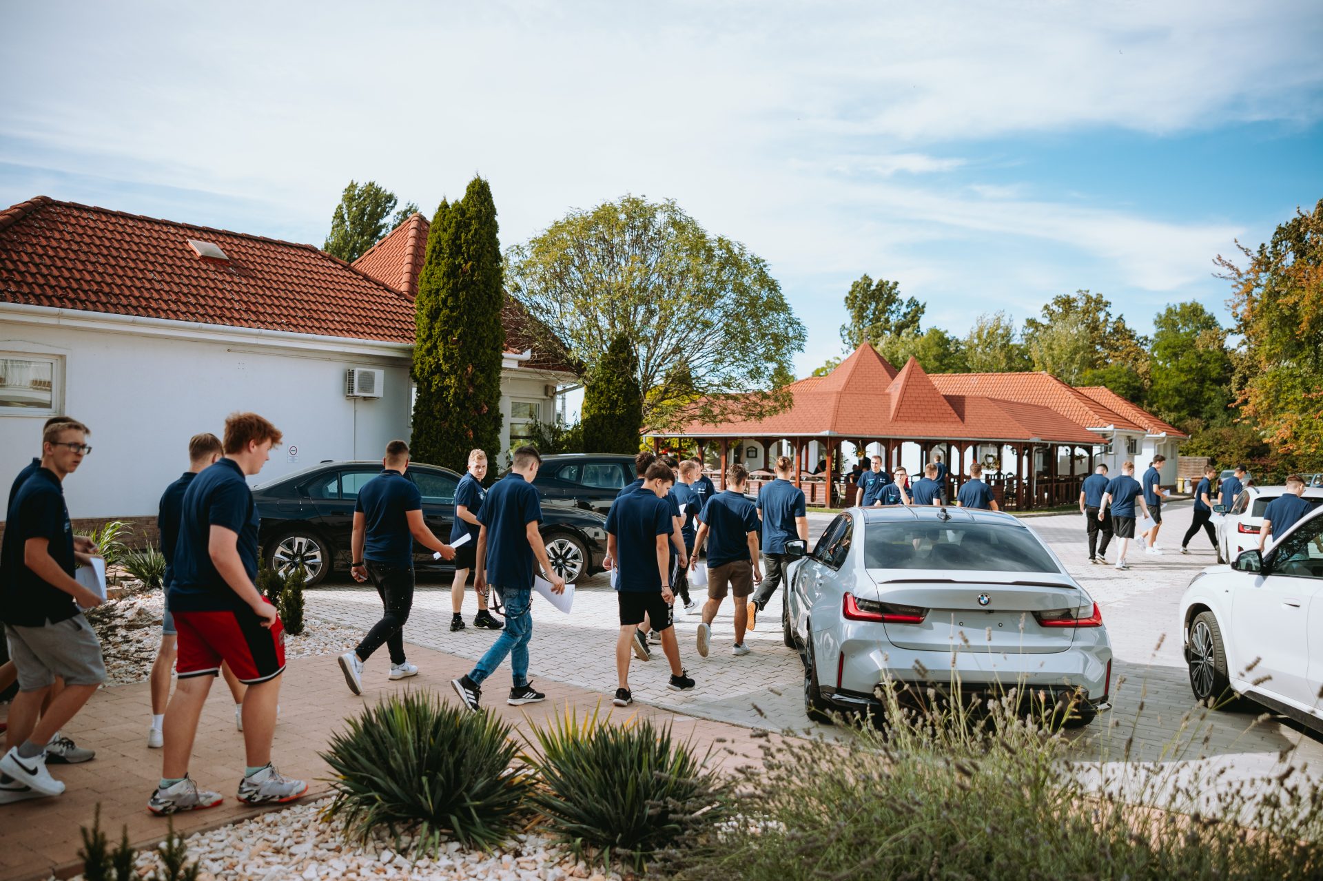 Apprentices are walking up to cars