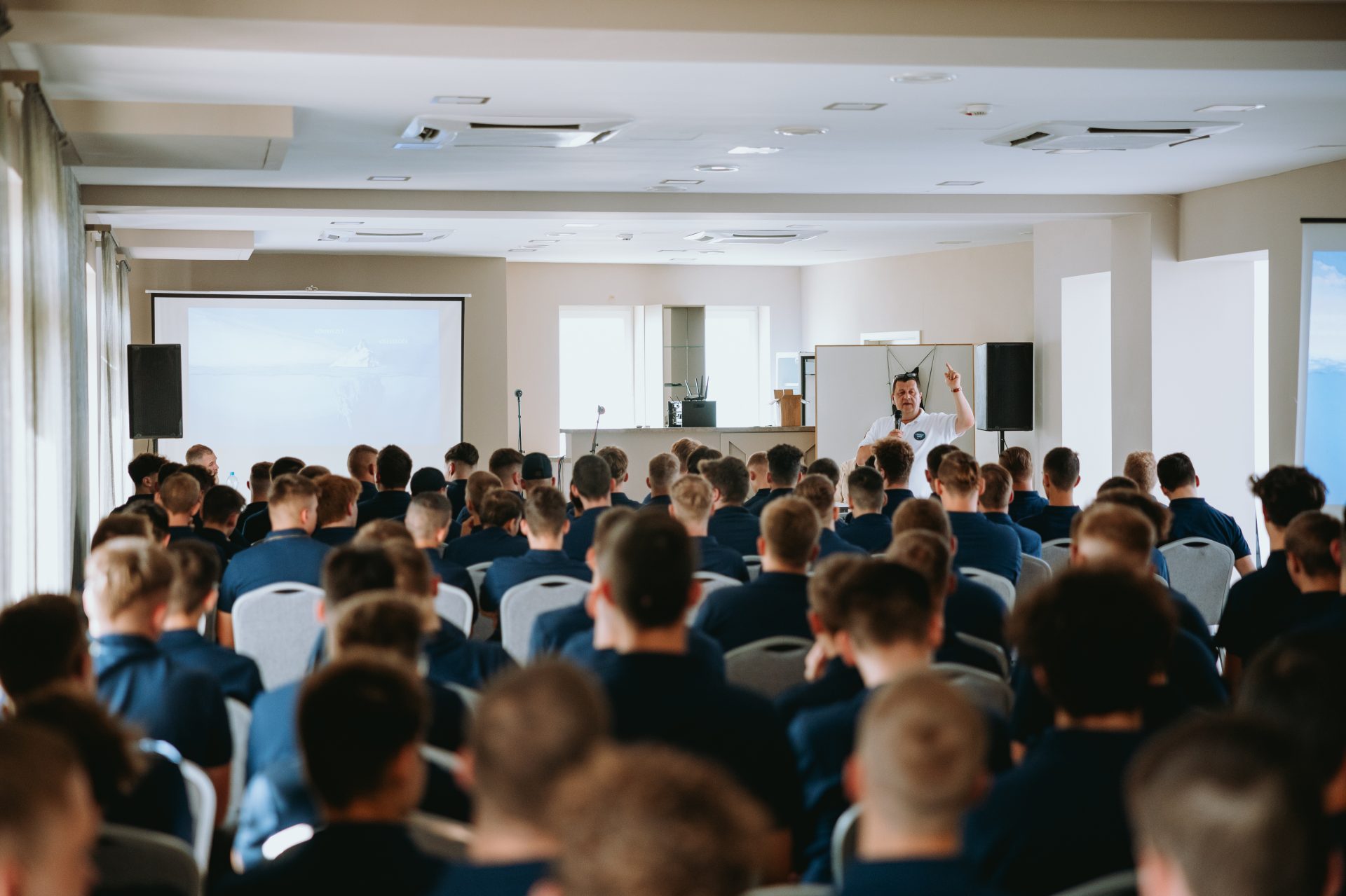 The apprentices are listening to someone presenting