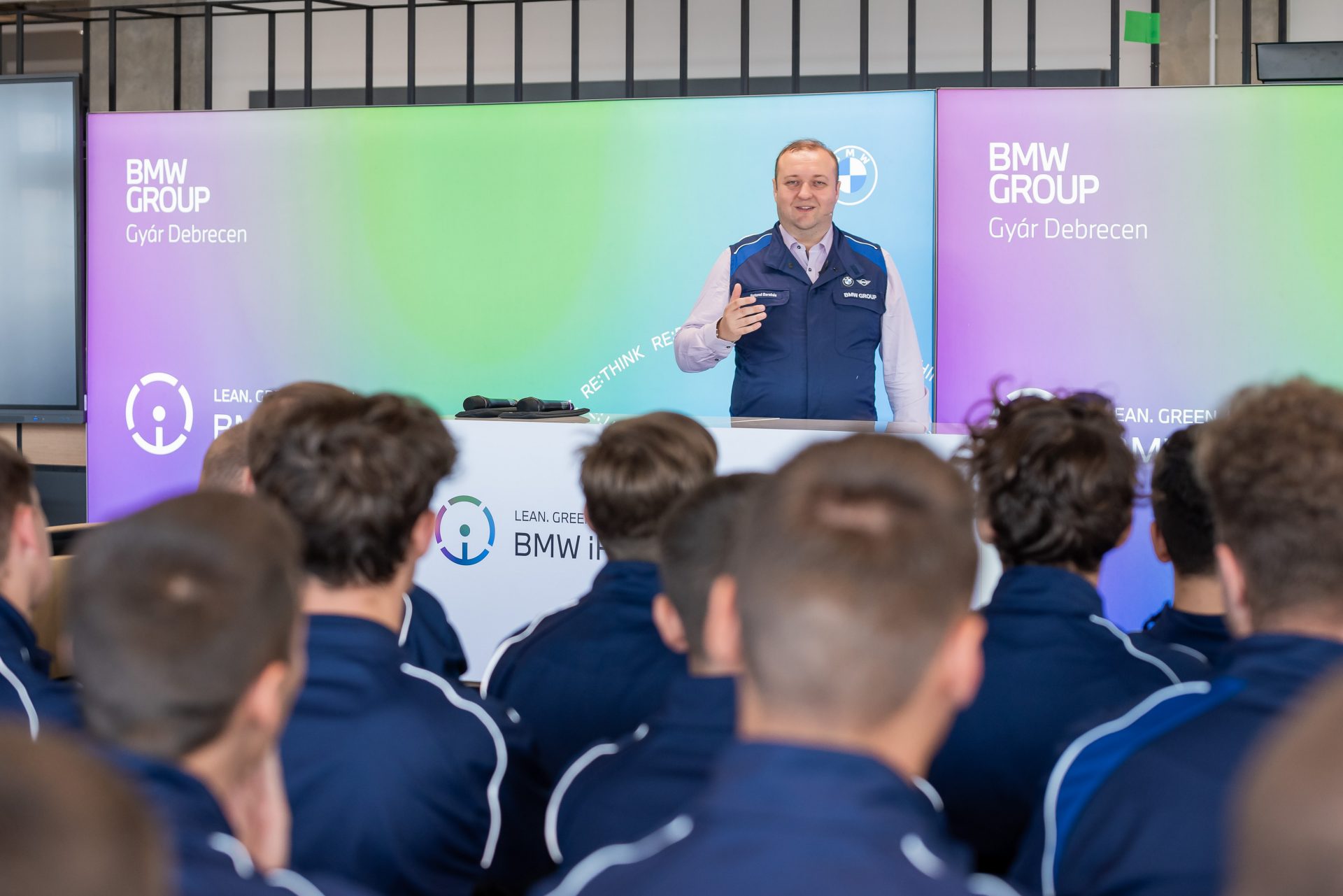 A man is presenting in front of the apprentices