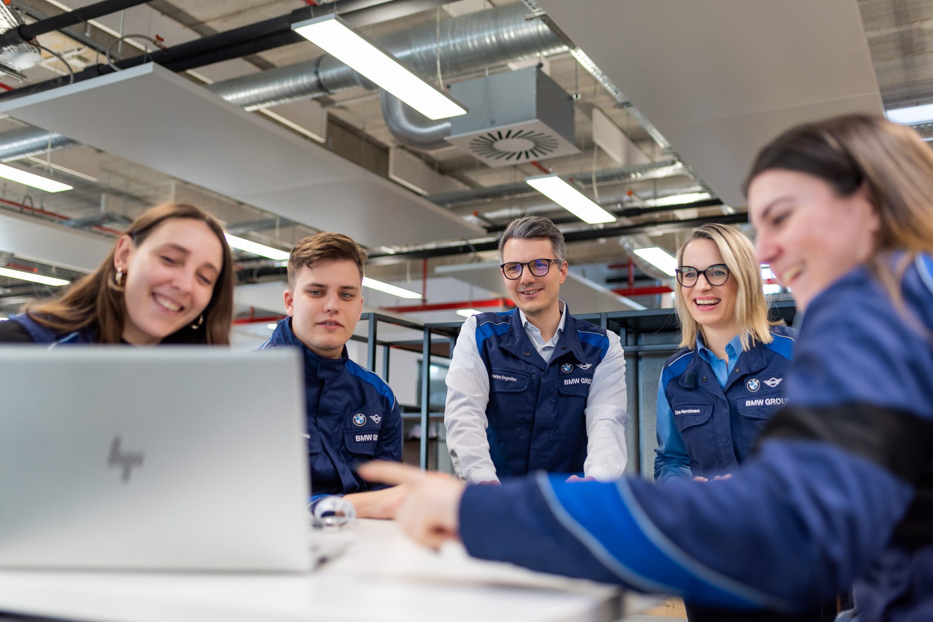 A group of people is looking into a computer