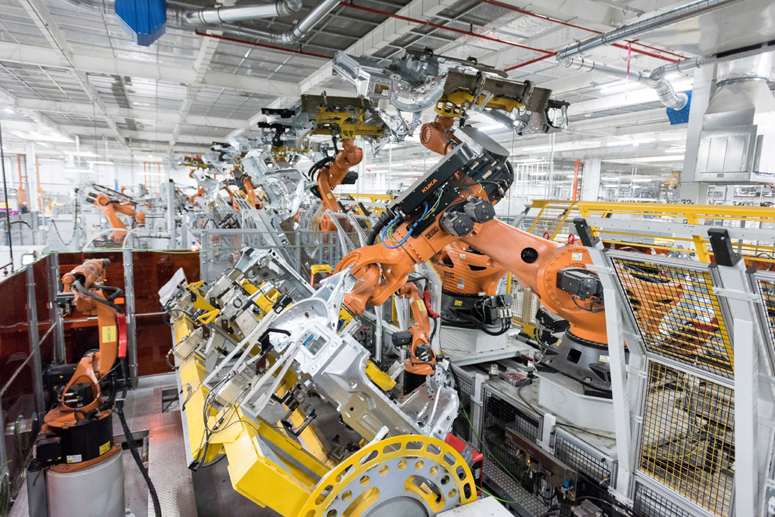 Entire process line in body shop with Titan robots handling the vehicle parts.