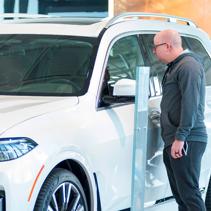 Visitors look at the X model display, showing current models produced at the plant. 