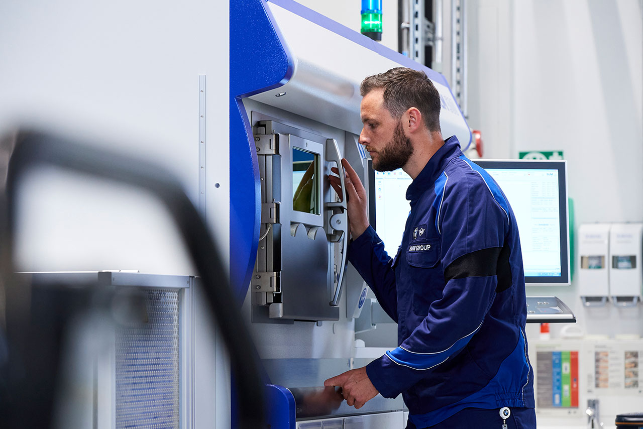 BMW employees at a 3D printer