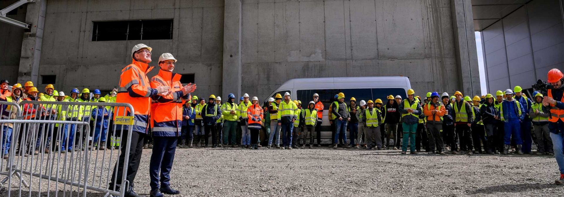 Construction workers are standing in a circle.