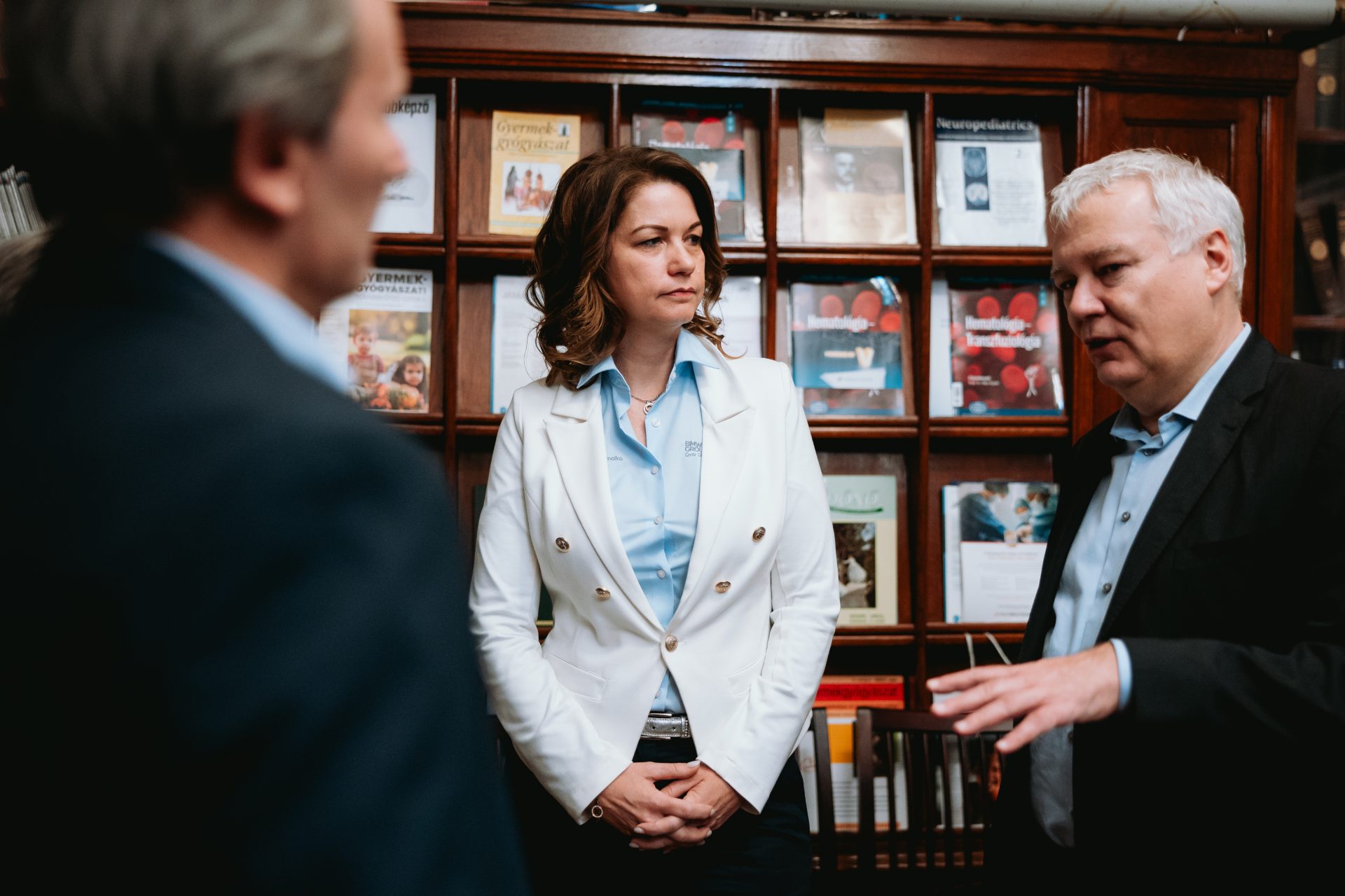 a woman and two men are talking