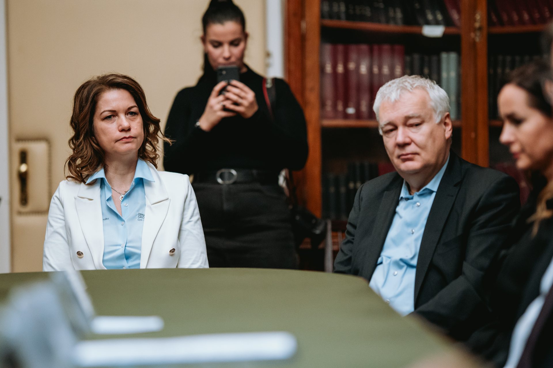 Three people are sitting at a table