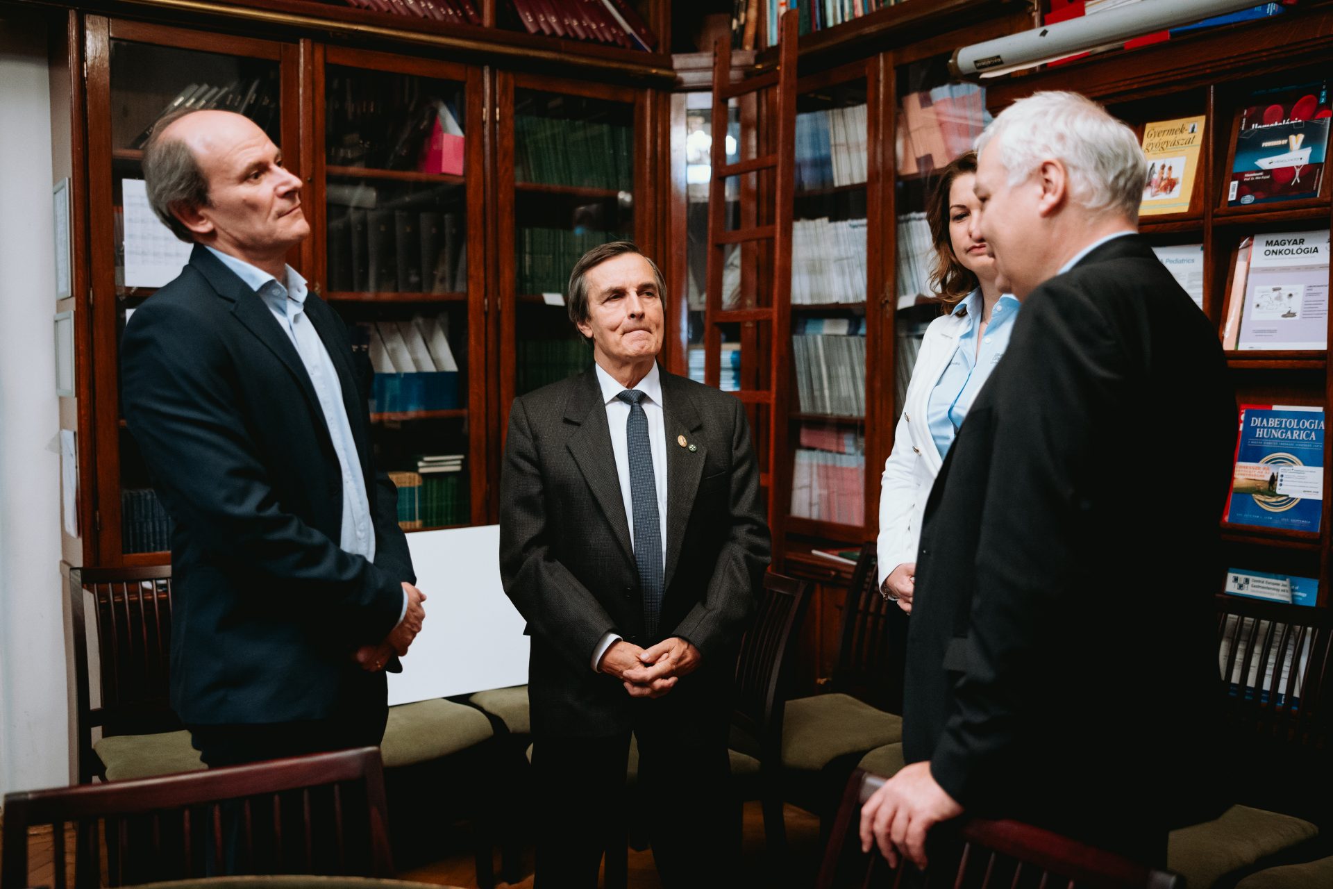 three men and a woman are standing together