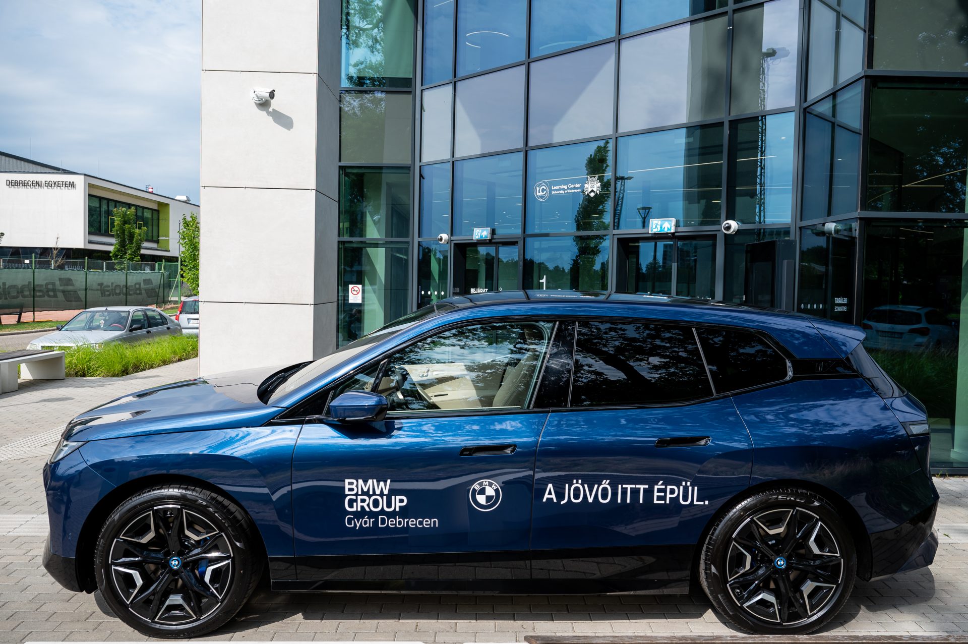 Bmw car with BMW Group Plant Debrecen stickers on it