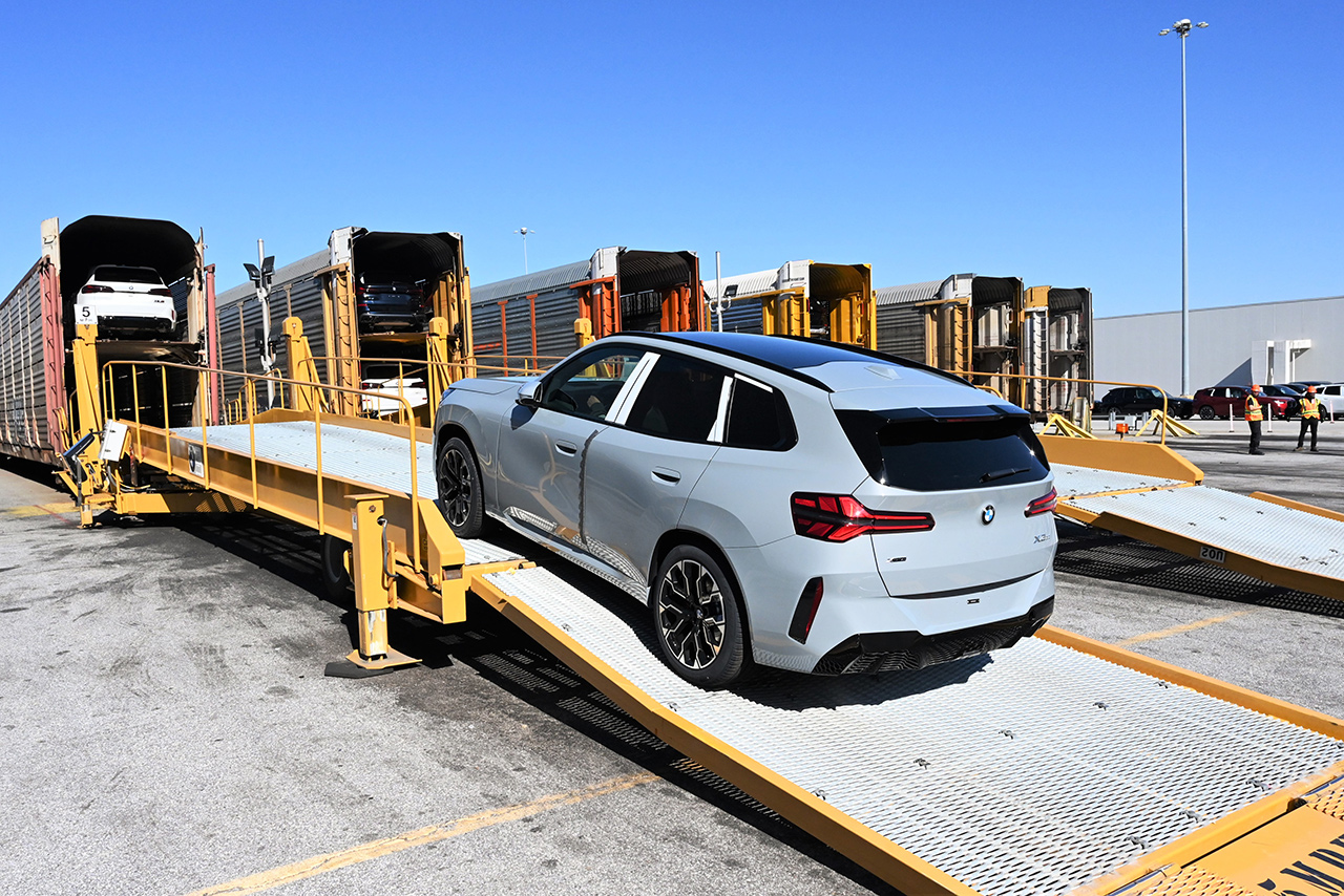 BMW X3 loading a car onto a train A bmw x3 is loaded onto a car train