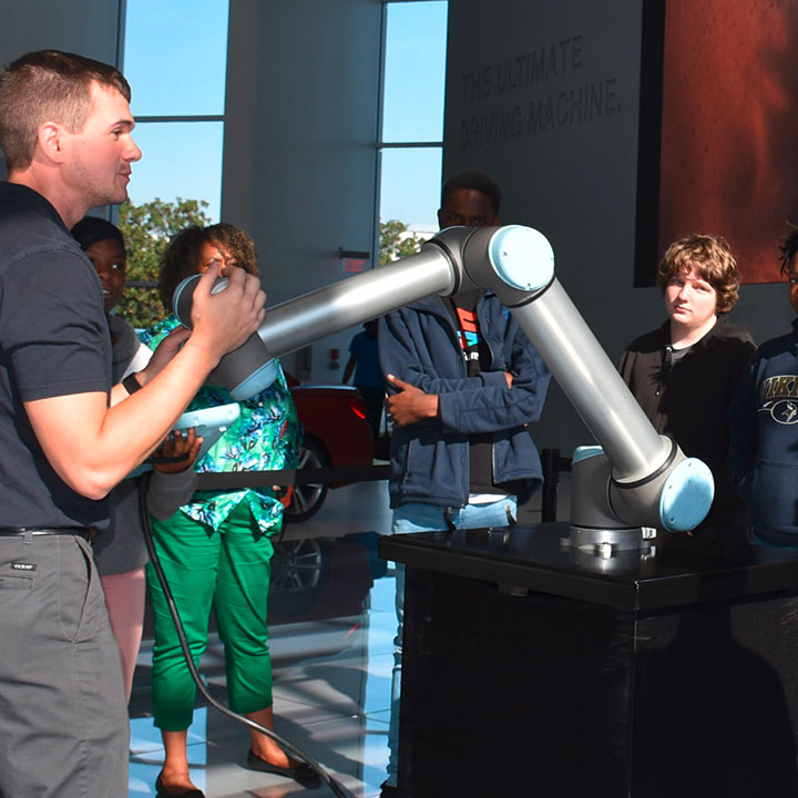 BMW Scholars show students how they can interact with a programmed robot. 