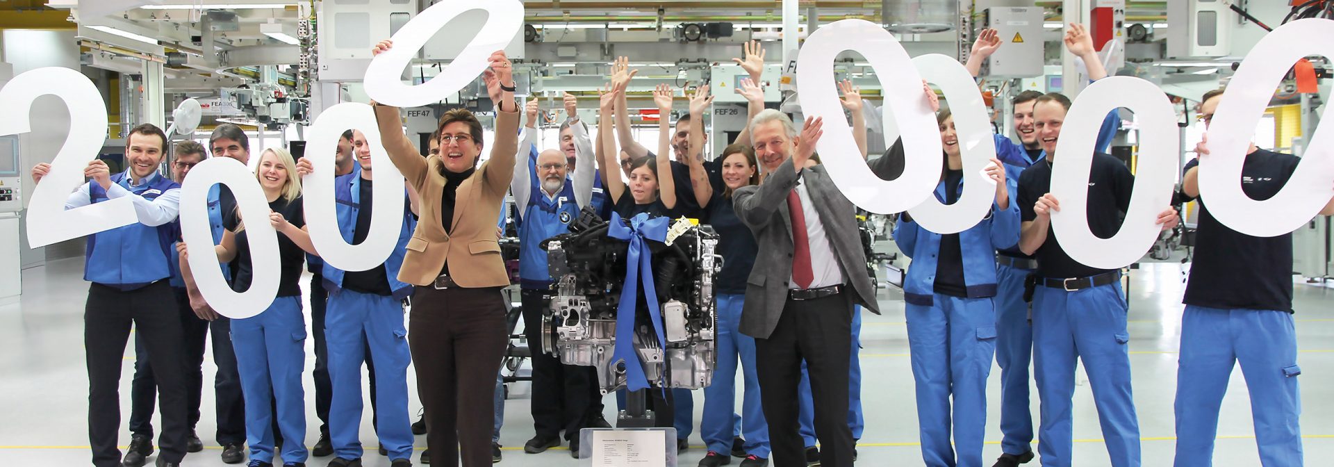 BMW employees hold the number 20 million in their hands